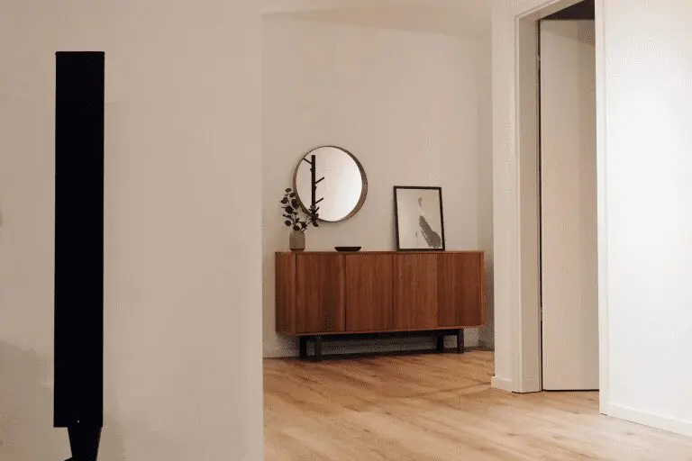 Minimalist hallway with wooden cabinet.