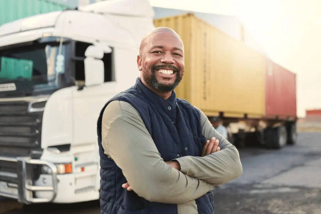 A man standing in front of a truck.