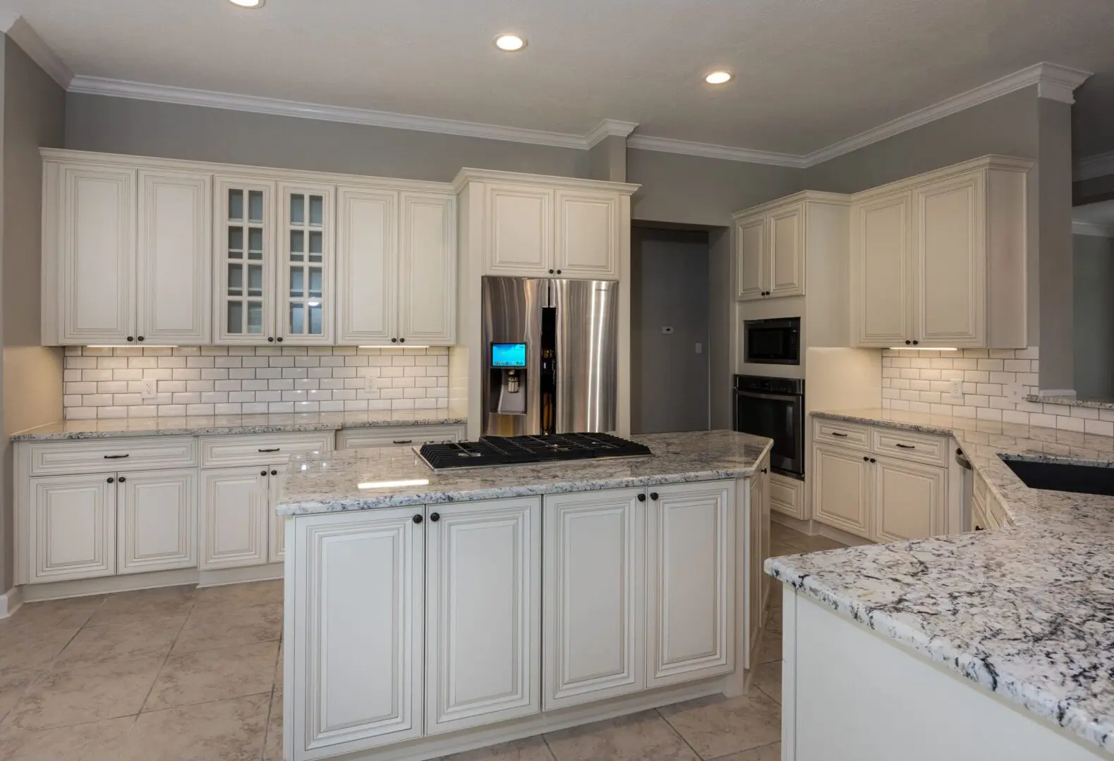 Cream kitchen with granite countertops and island.