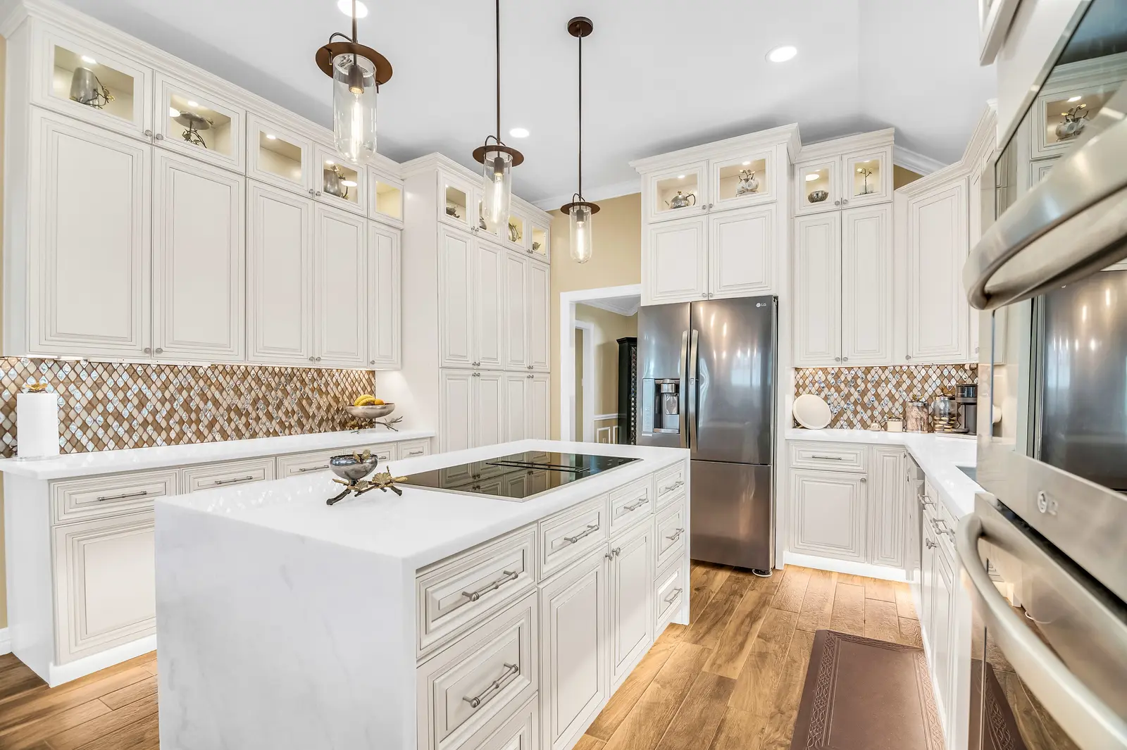 Elegant kitchen island with white cabinets.