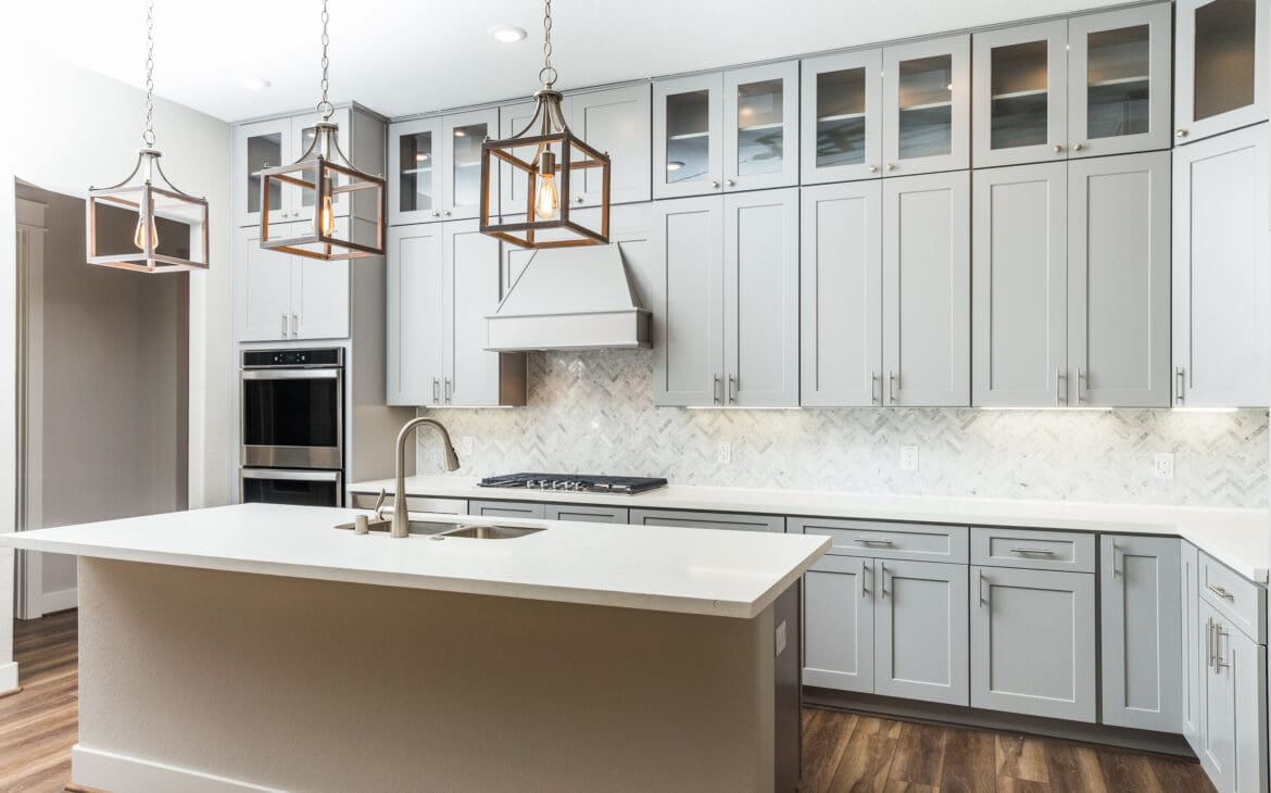 Modern kitchen with gray cabinets and island.