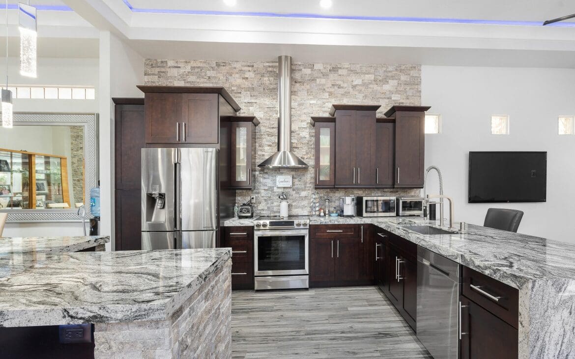 A kitchen with stainless steel appliances and wooden cabinets.