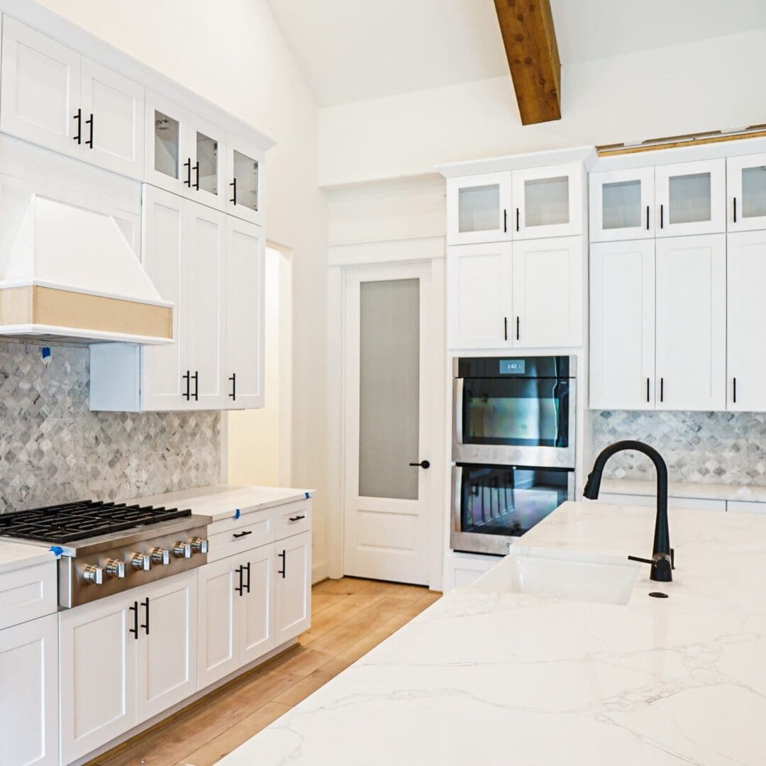 Modern white kitchen with quartz counters.