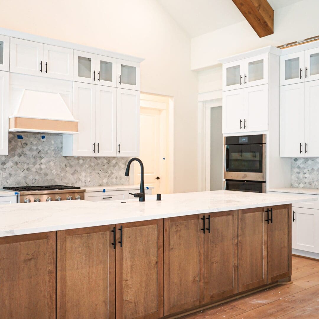 Modern kitchen island with white cabinets.