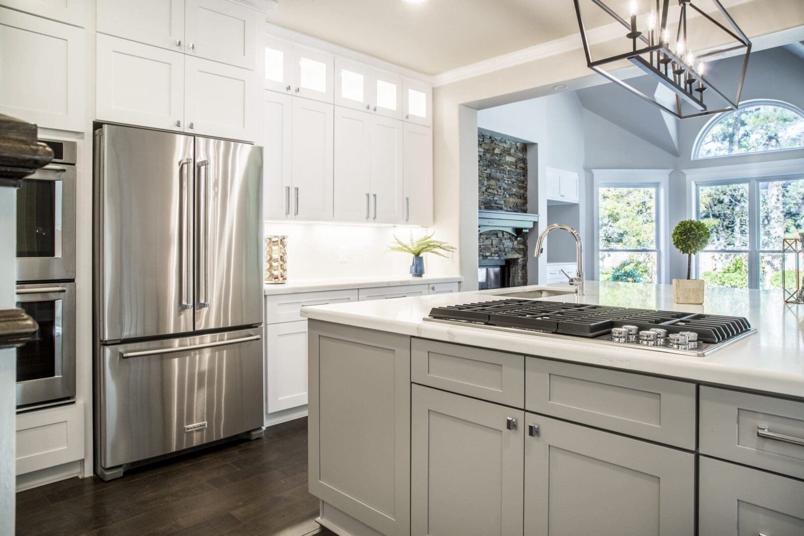 Modern kitchen island with stainless steel appliances.