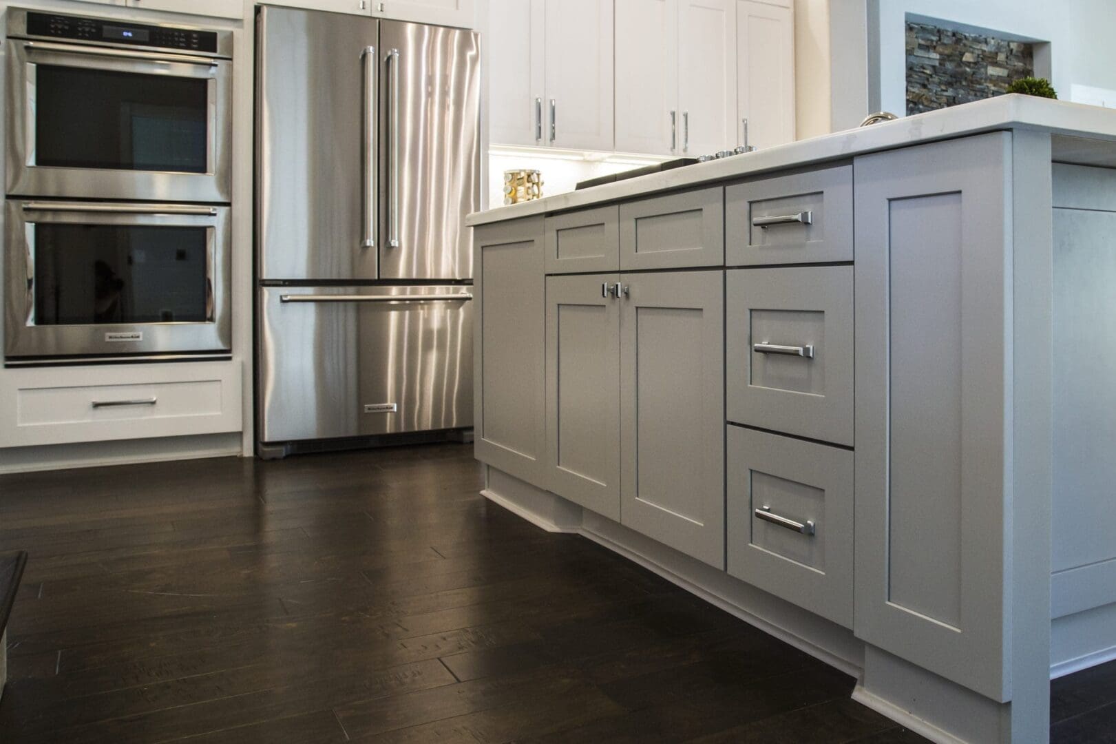 Modern kitchen island with gray cabinets.