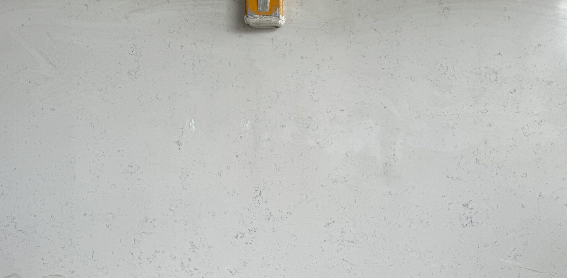 A white wall with a yellow box on it.