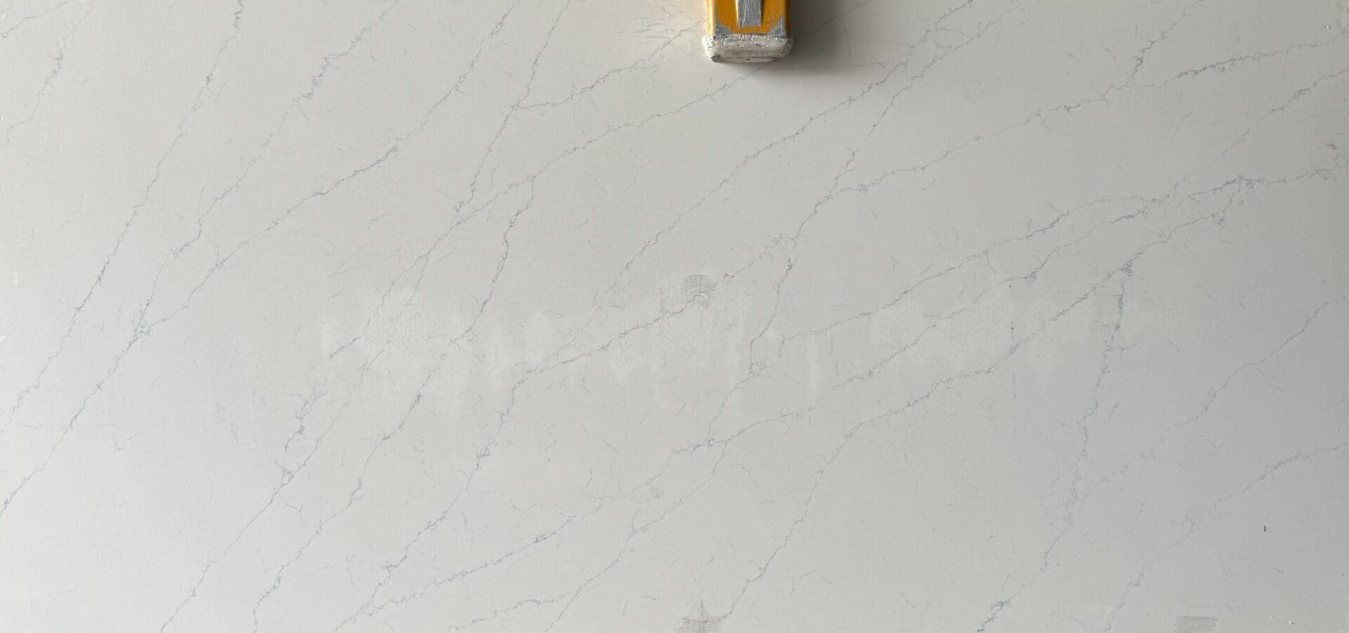 A yellow and white wall with some kind of object