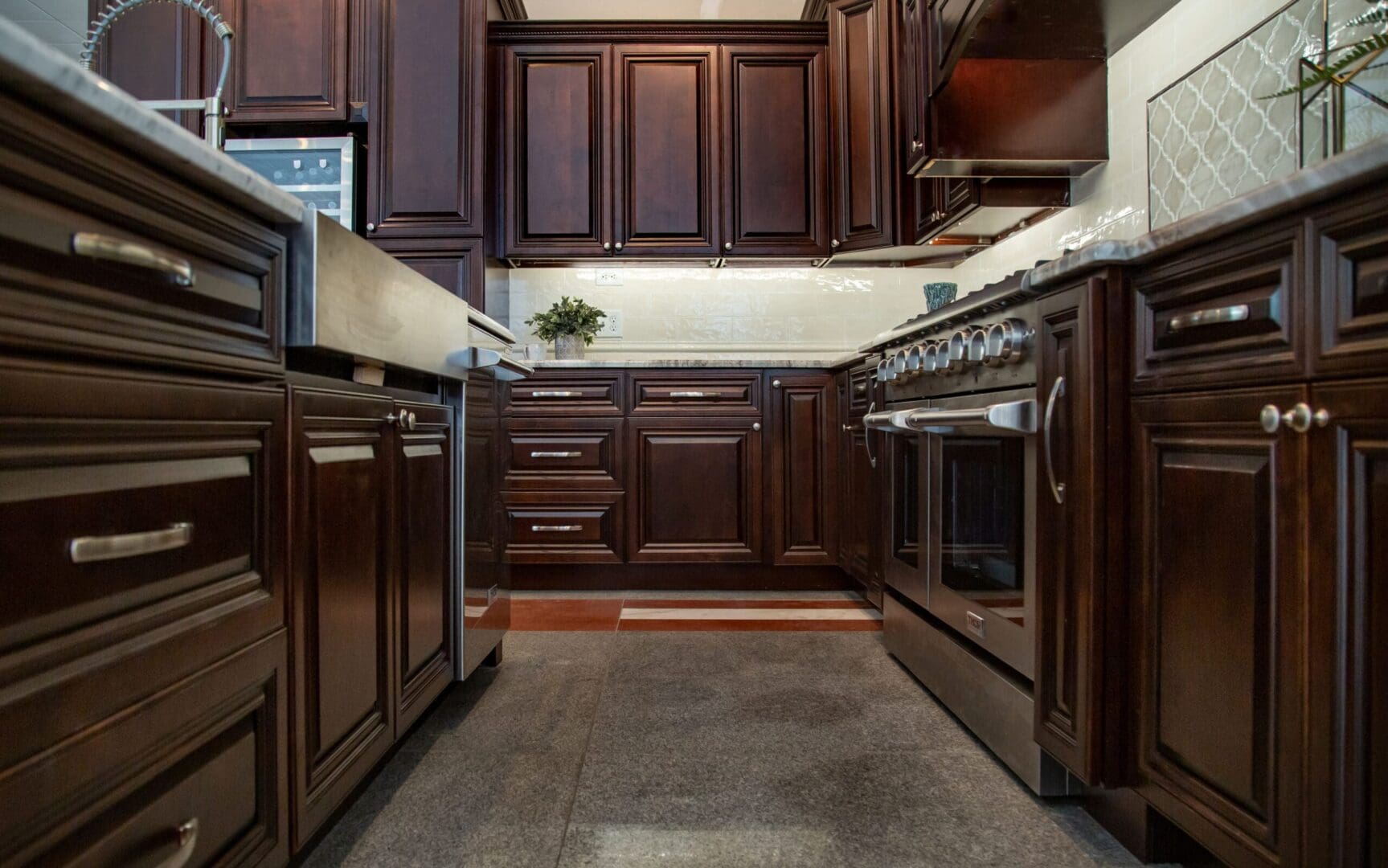 Dark wood kitchen with stainless steel appliances.