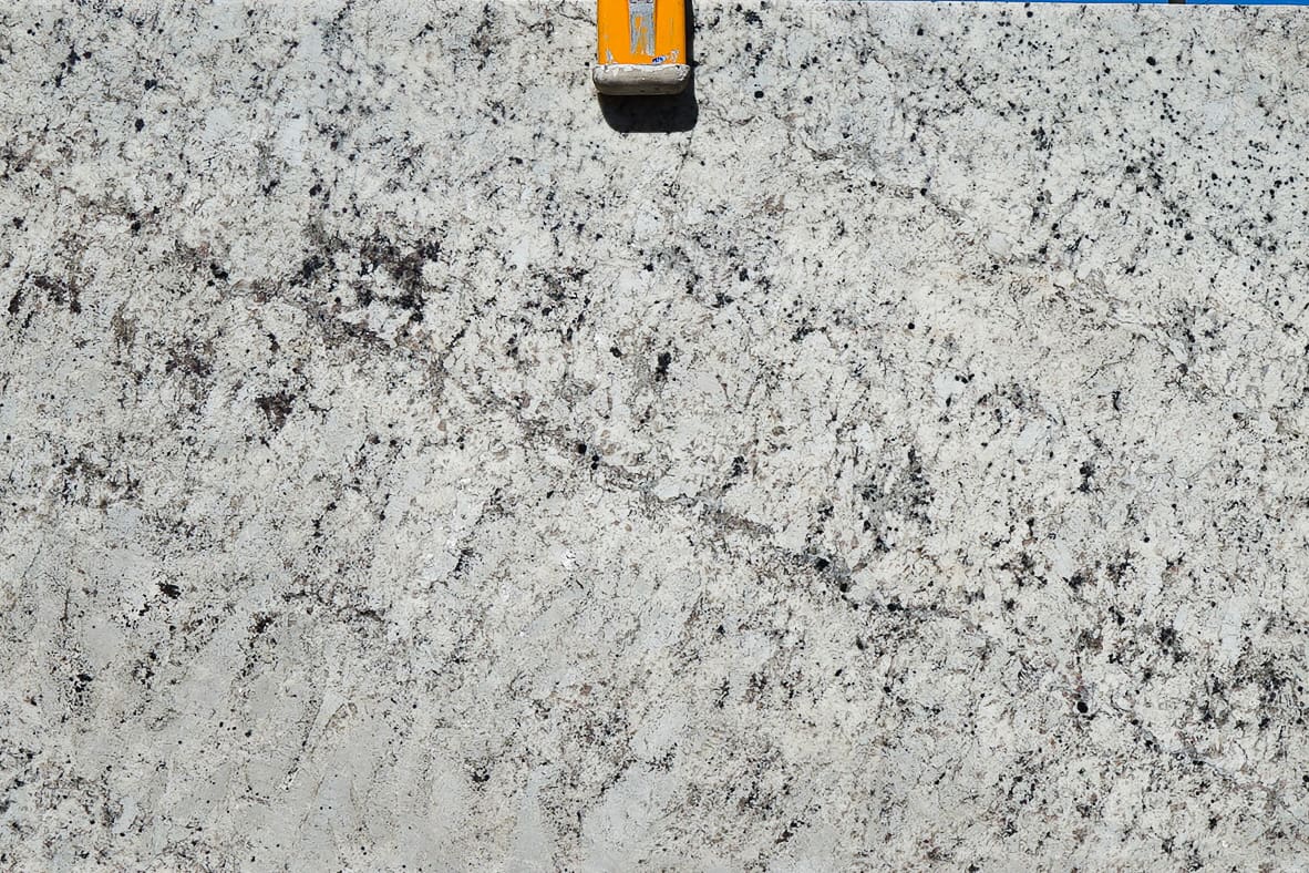 A cell phone is on top of the white granite.