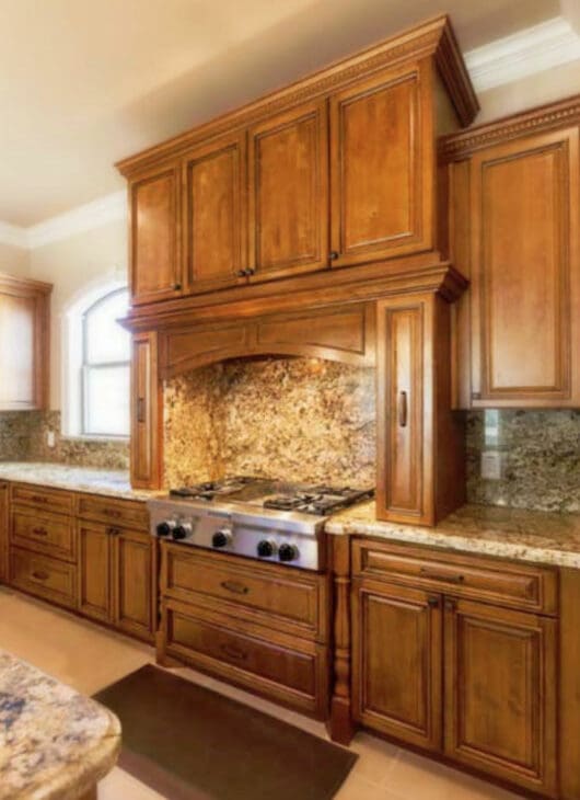 A kitchen with wooden cabinets and granite counter tops.