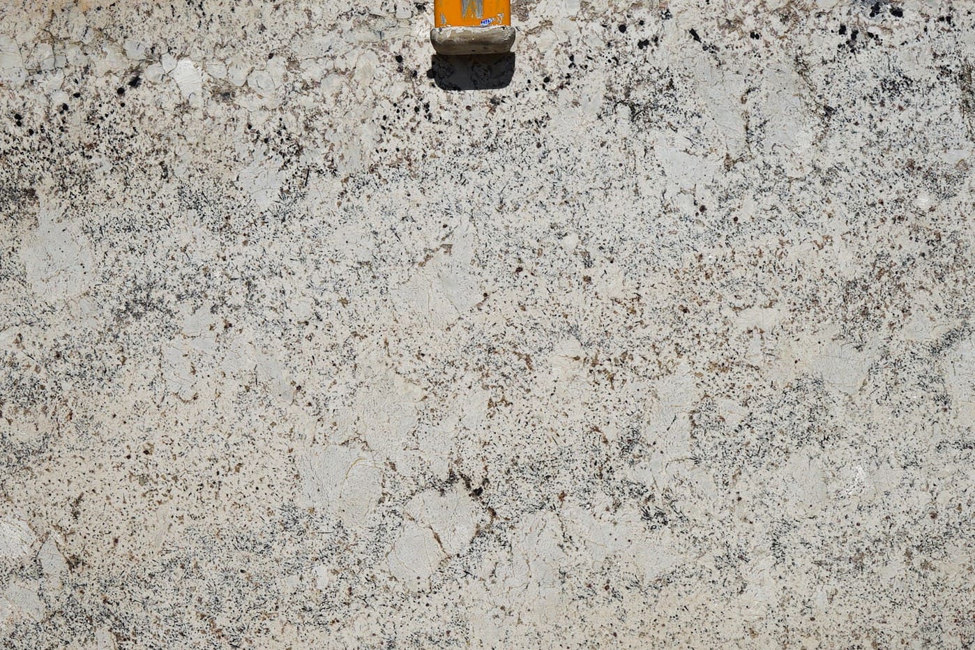 A yellow object sitting on top of a white surface.