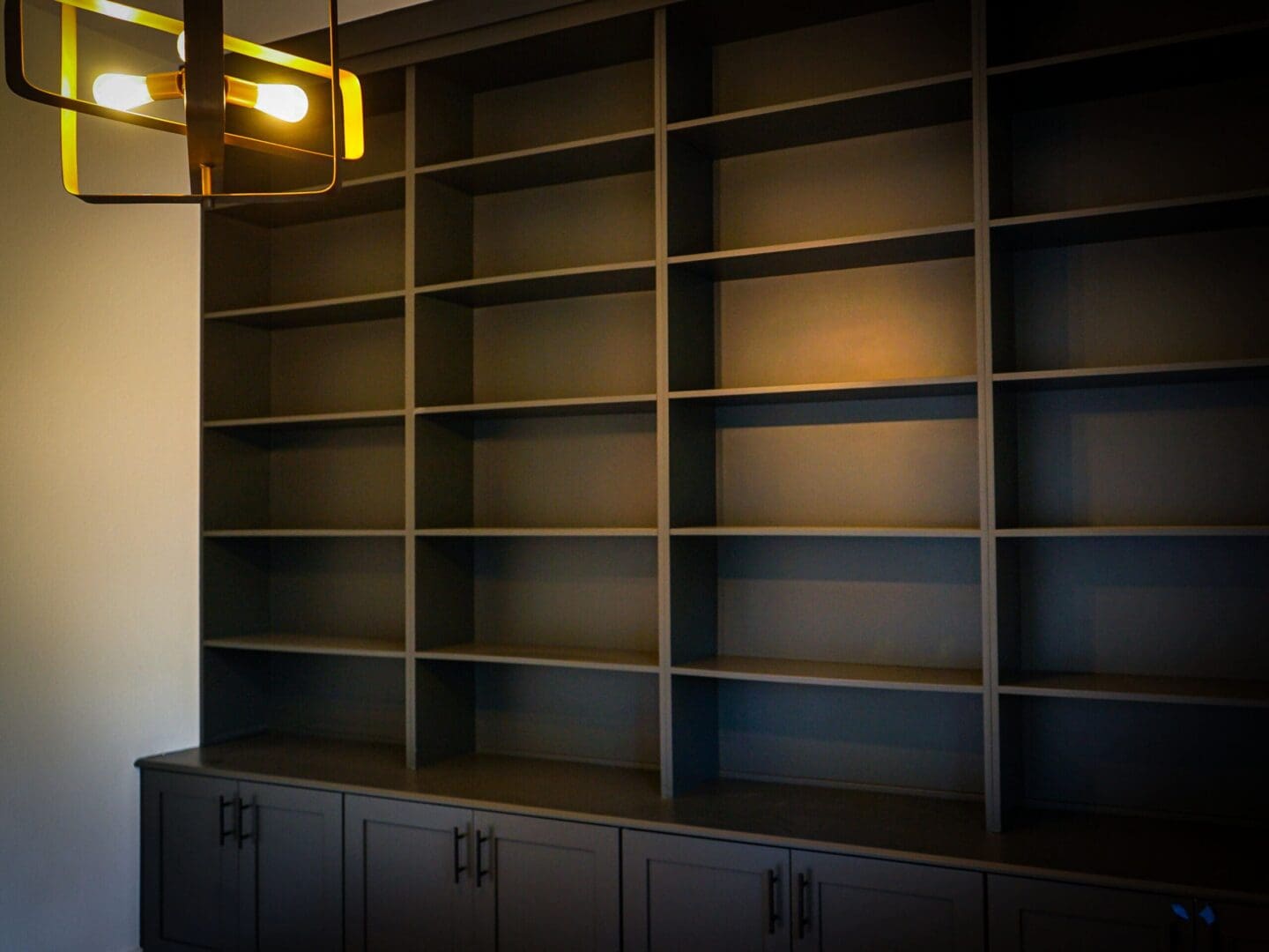 Empty dark built-in shelves and cabinets.