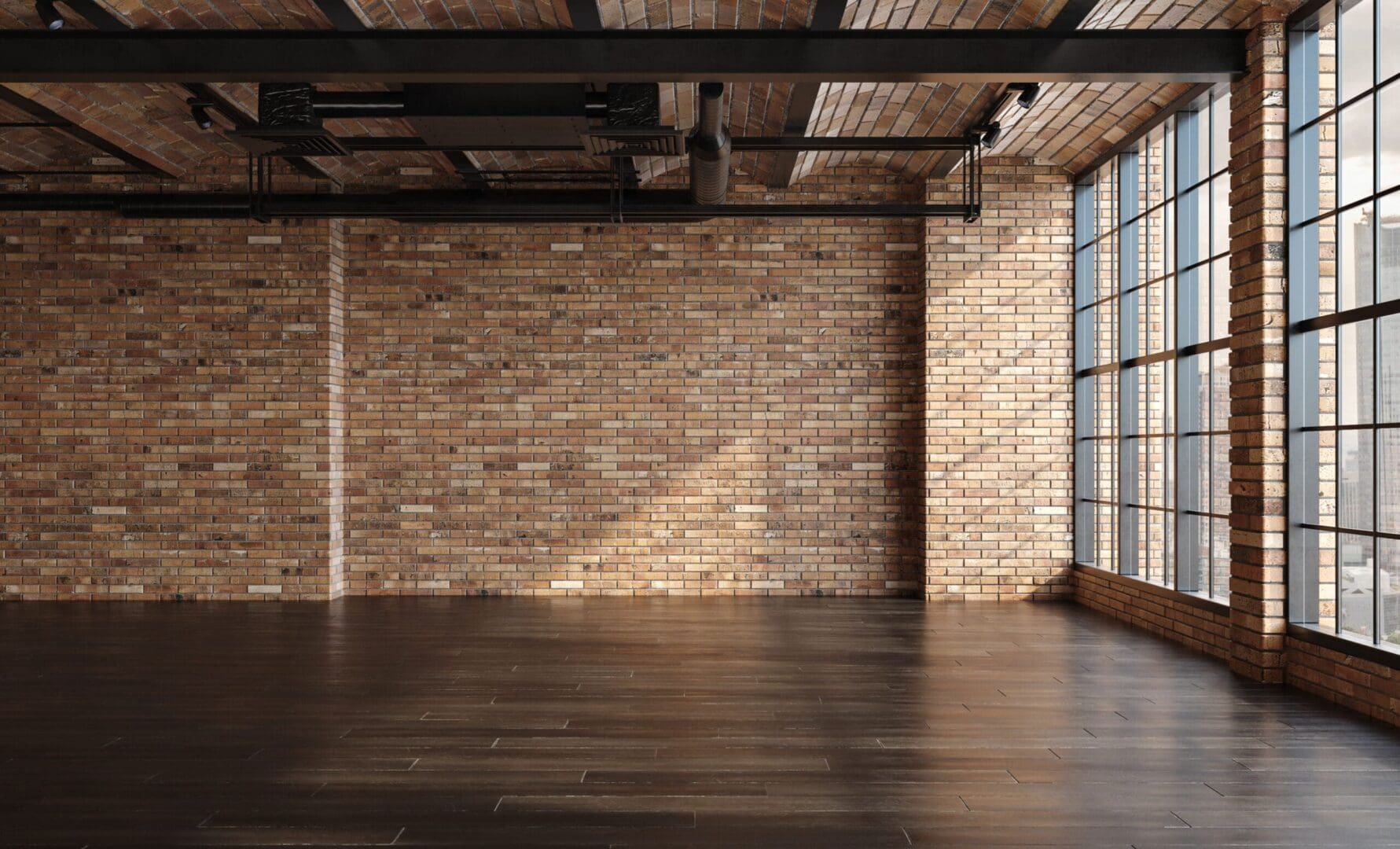 Here's an alt tag for the image: Empty loft space with brick wall and large window.